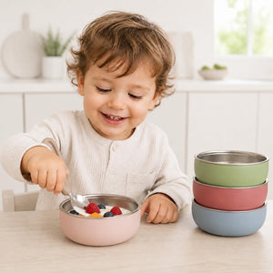 Multicolor stainless steel kids bowls – kids eating from Multicolor stainless steel bowls at the table – Monkey Proof