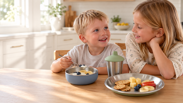 Kids eating snacks from Monkey Proof stainless steel bowl, plate and toddler cup at the kitchen table
